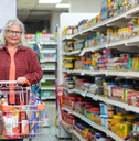 senior woman purchasing at grocery shop