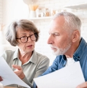 Concerned senior couple doing paperwork