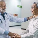 senior doctor and elderly patient shaking hands