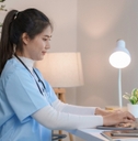 nurse working at home desk