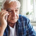 tensed senior man talking on mobile phone 