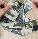 man looks through his old photographs