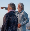 senior couple standing at sunset
