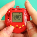 tamagotchi in red plastic case