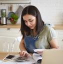 woman doing calculations managing home budget