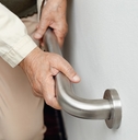 elderly woman holding handrail