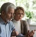 Shocked elderly spouses getting personal information hacked
