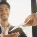 Happy office worker receiving extra money