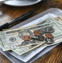 paying bill tab with money