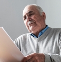 senior man reading a paper document