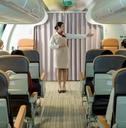 Flight attendant giving safety instructions to passengers