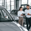 man with woman in the car dealership together