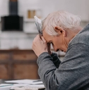 Stressed senior man sitting at table