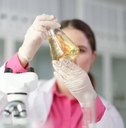 Chemist looking at flask