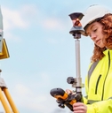 Red head woman in yellow jacket uniform working with mapping and surveying