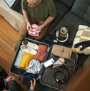 couple diligently packing suitcase
