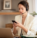 businessswoman wearing headset and using smartphone