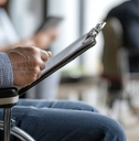 Man in wheelchair with paperwork