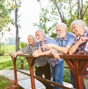 senior group is standing on a small bridge