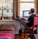 A man drinking coffee while working from home