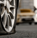 Close-up of a flat tire on a car