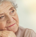 Close-up of an elderly woman with a reflective look on her face