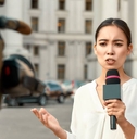 TV reporter presenting the news outdoors