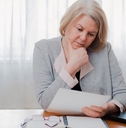 senior woman reading paper documents