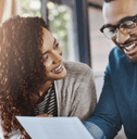 Smiling couple working on bills