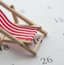 Red beach chair on white blank calendar background copy space. 