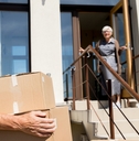 senior couple unloading cardboard boxes