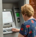Senior woman is using an ATM