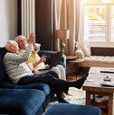Senior couple on a sofa in the living room of their home