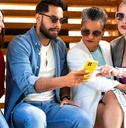 Group of diverse people using smartphone outdoors