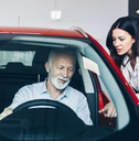 man choosing a new car at car showroom