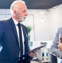 senior man boss talking to female employee
