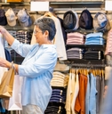 Happy Asian senior woman shopping at department store