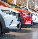 car at a bustling car dealership showroom