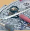 stethoscope laying on us bills