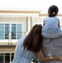 happy family in front of their new house