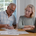 Senior couple scan qr-code to pay bill