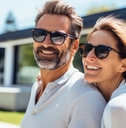 40 year old couple is having fun in front of their modern house