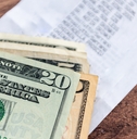 A stack of US Dollar bills on a table
