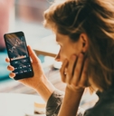 woman using mobile phone investing 