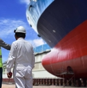 Engineers discuss ship repair plans on the dock