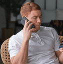 person on phone with credit card