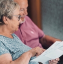 senior couple at home paying bills