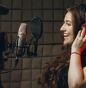 Woman recording voice in studio