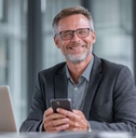 smiling businessman holding smartphone