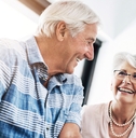 happy senior couple in home planning for retirement